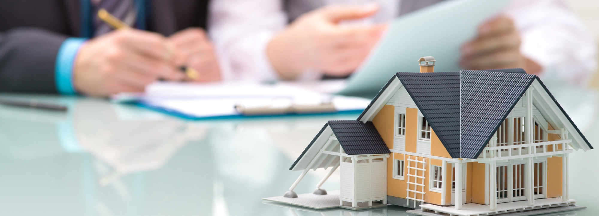 Real estate concept with small custom home model Real Estate custom homes