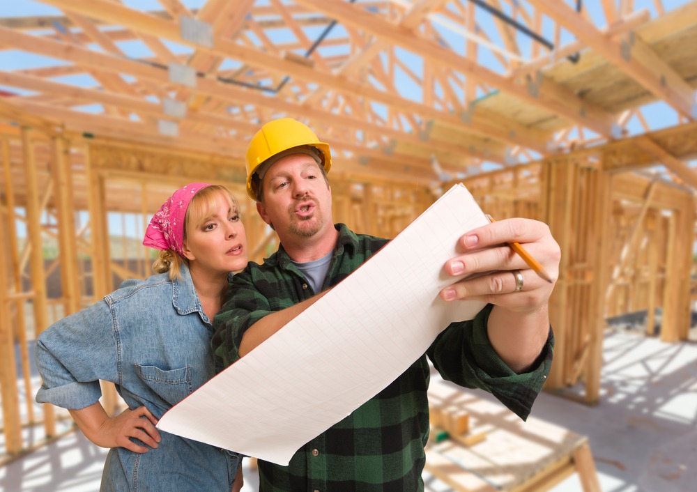 Houston custom home builder discussing plans with client Contractor showing plans