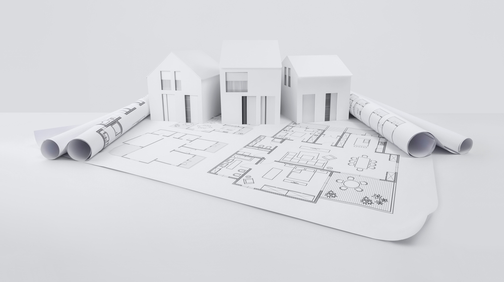 architectural model of houses on blueprint draw, isolated on white background, banner layout with copy space for building construction plan