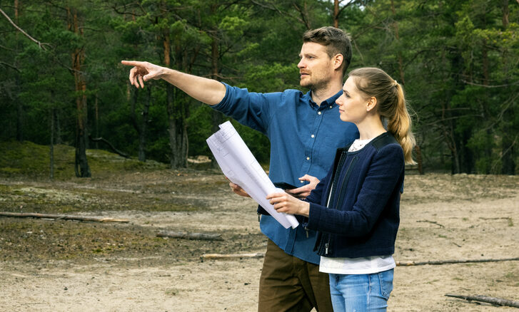 young couple choosing a plot of land for construction.