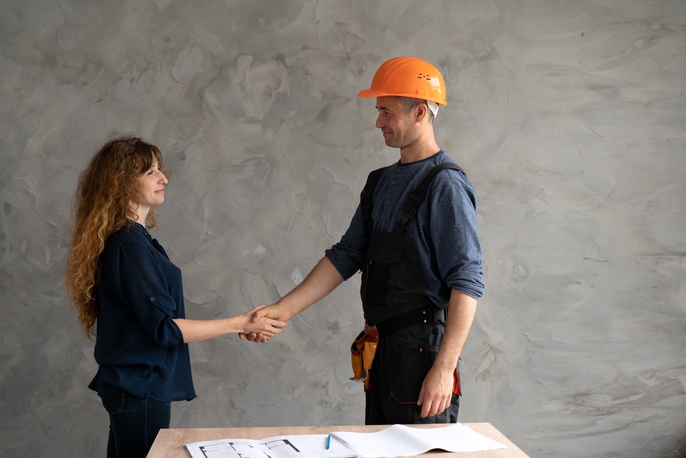 a builder and a woman customer concluding a deal